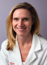 Smiling woman in doctor's white coat
